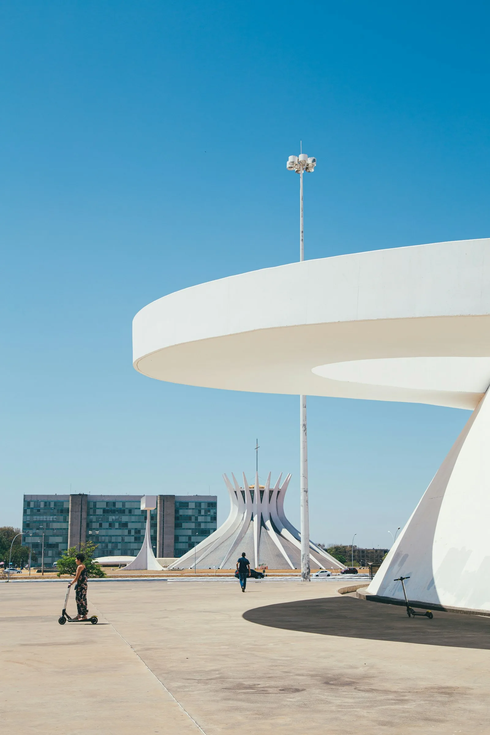 Brasília's modernist concrete architecture under a bright blue sky.