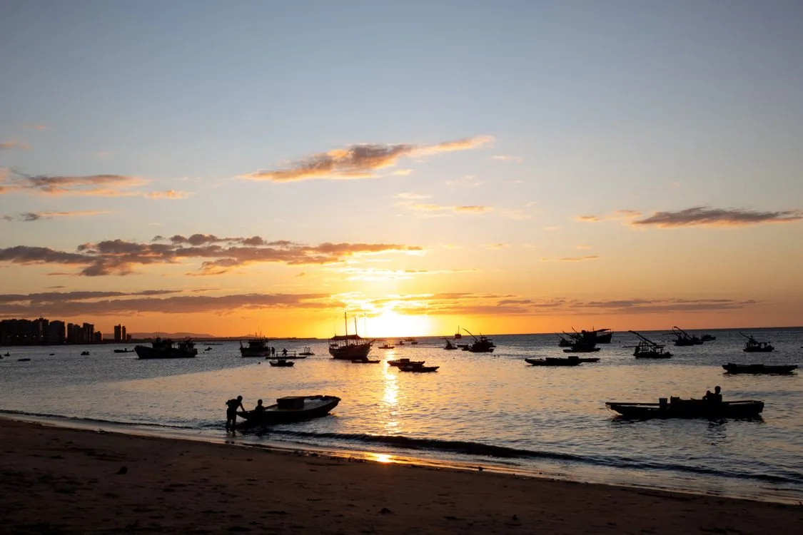 Sunset over fishing boats on the coast of Ceara, used for Fortaleza beach and night-safety guidance.