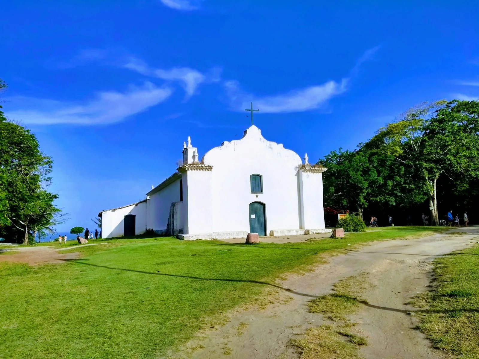 Colorful colonial houses and the historic church surrounding the Quadrado, the central village square of Trancoso, Bahia, Brazil.