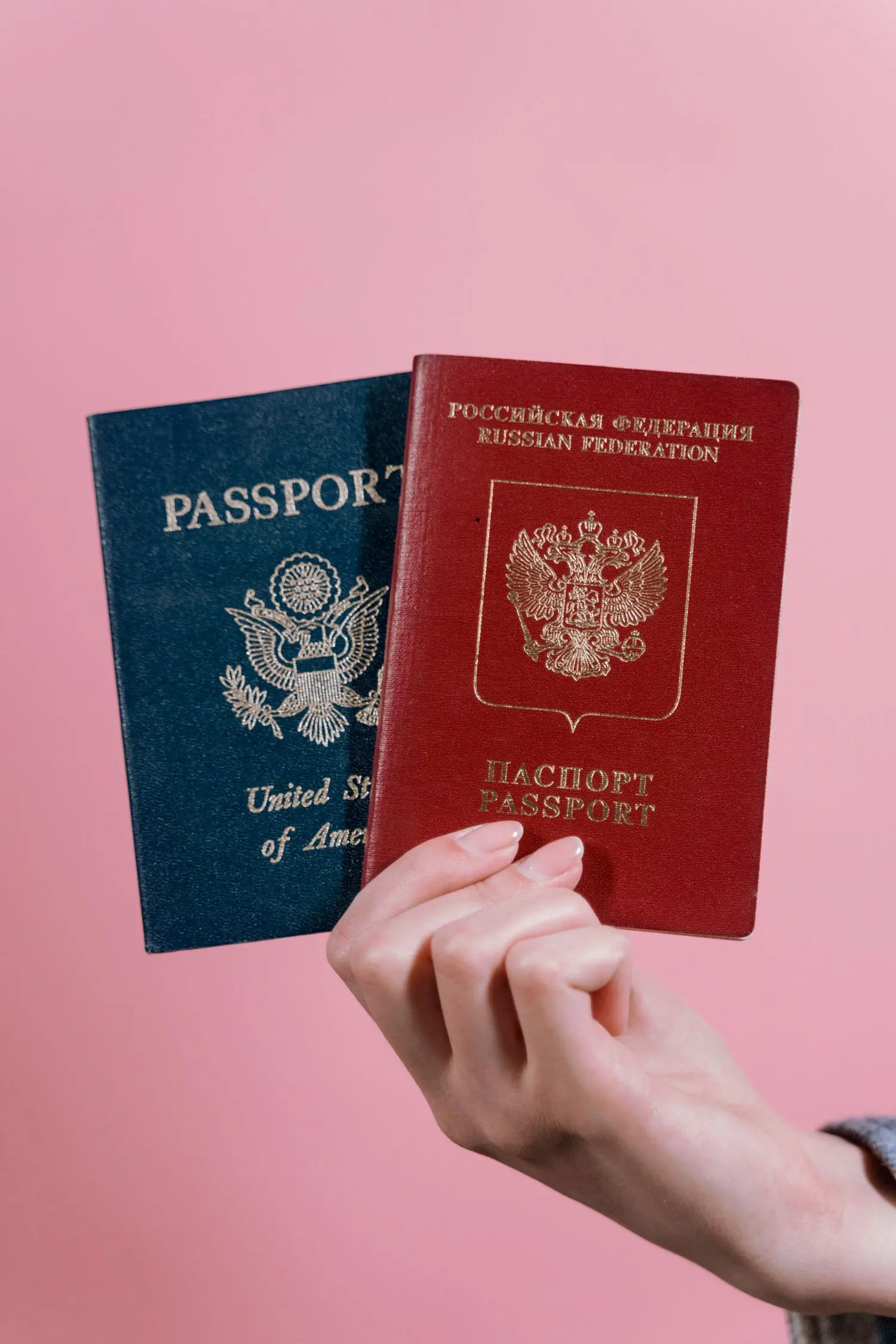 A hand holding a US passport, illustrating the entry and safety questions American travellers ask about Brazil.