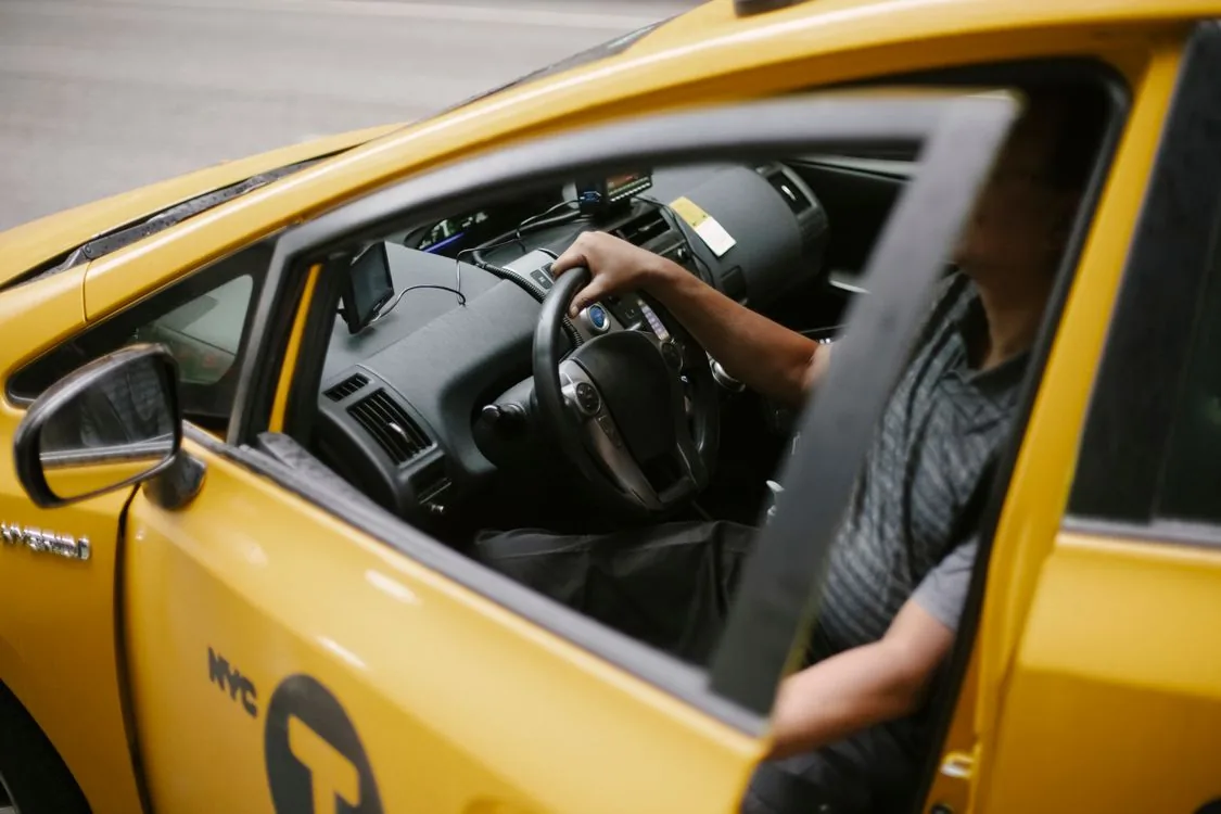 Rideshare driver waiting in his car for a passenger — Uber and 99 are the transport most tourists rely on in Brazil.