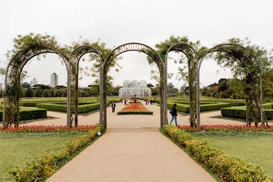 Arched walkway at Curitiba's Jardim Botânico leading toward the Art Nouveau greenhouse — the southern Brazilian city's most recognizable landmark.