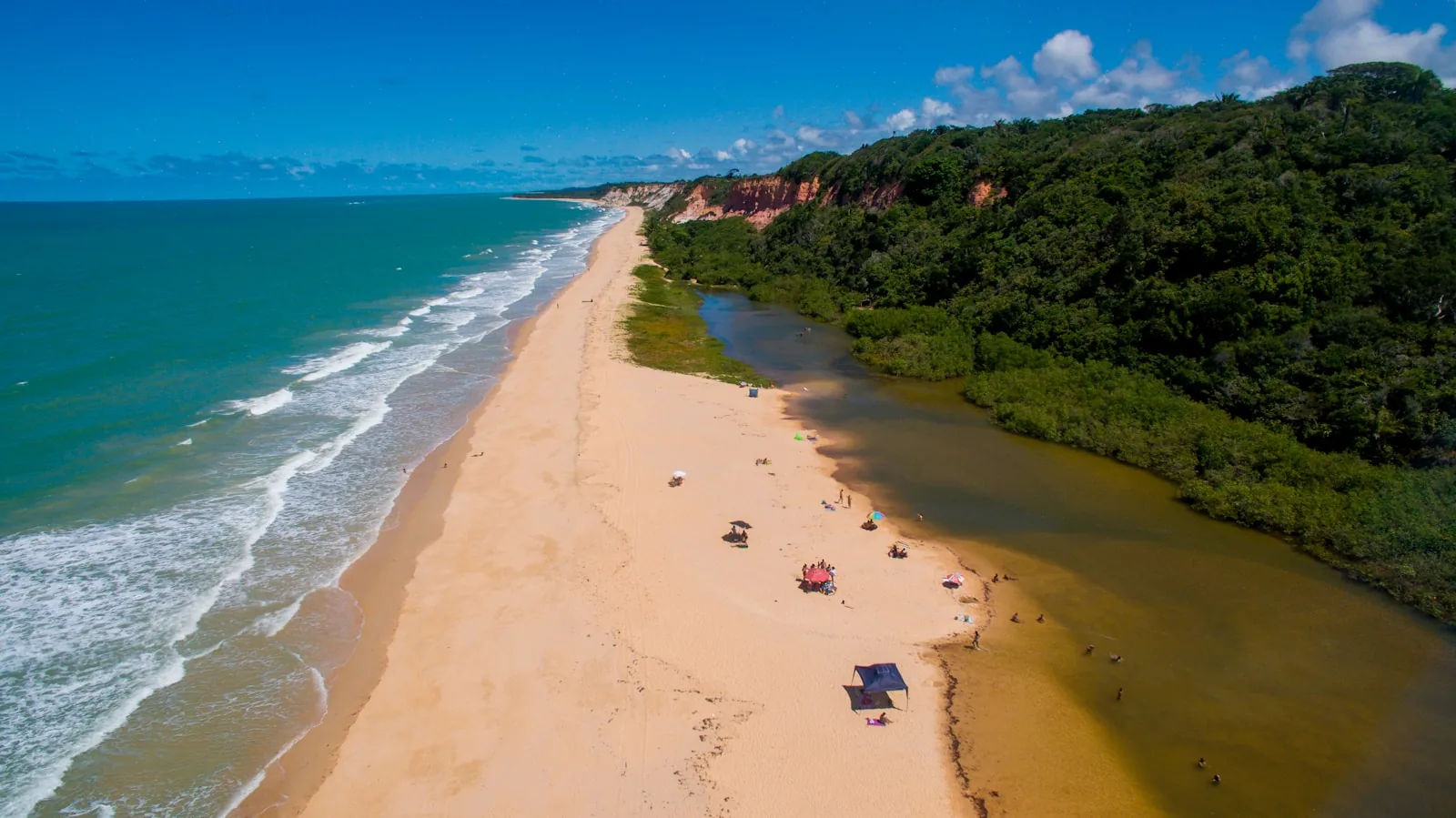 Visitors relaxing on the beach near Trancoso during the day