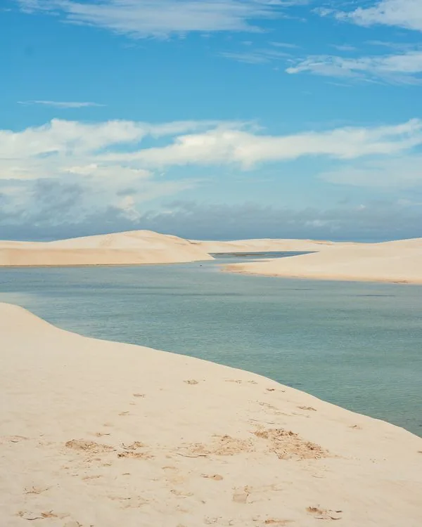 Wide sand dunes meeting the Northeast Brazilian coast — the dune-and-beach landscape that defines Genipabu and the Rio Grande do Norte north coast.
