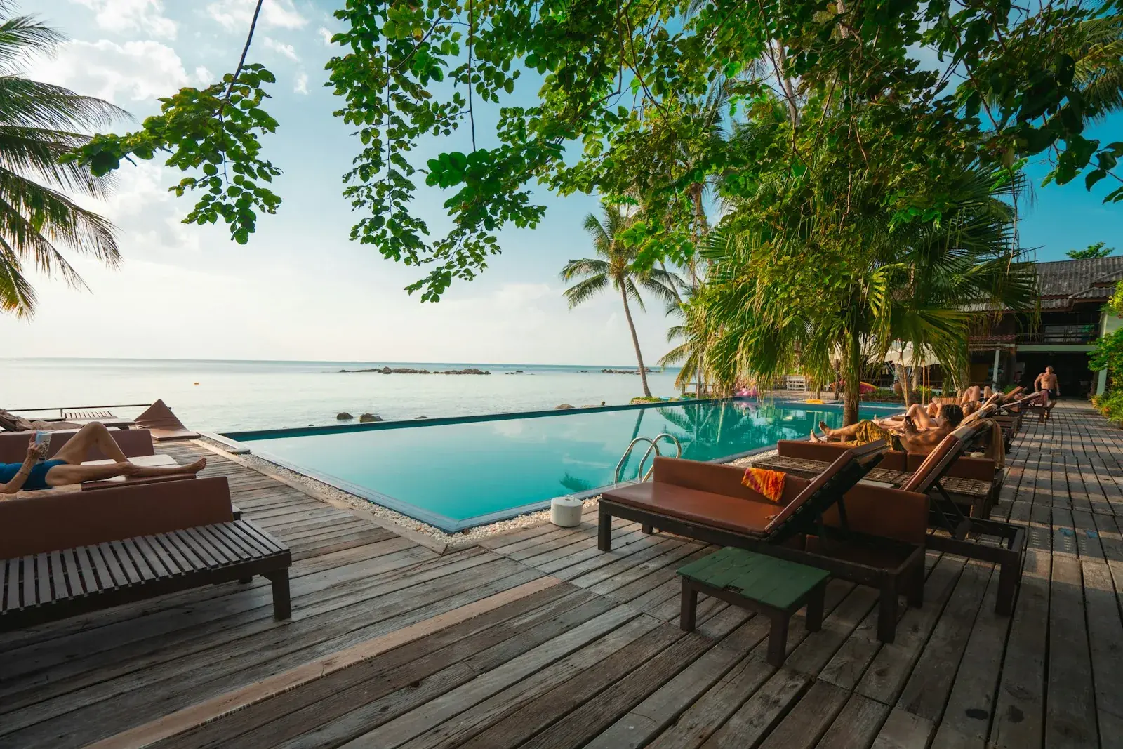 Wooden hotel deck with tables and chairs overlooking the water